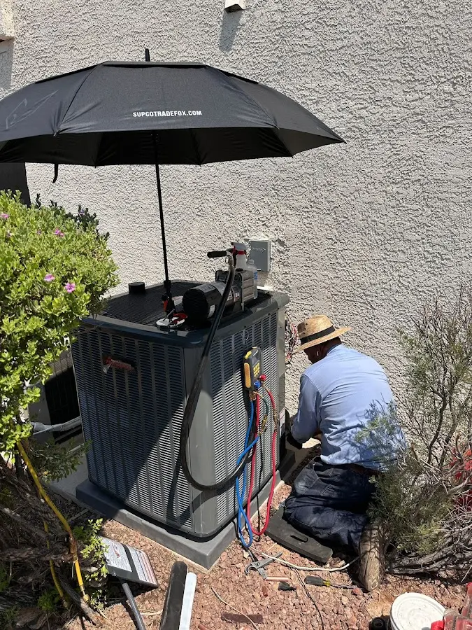 HVAC technician performing outdoor AC maintenance in Scio